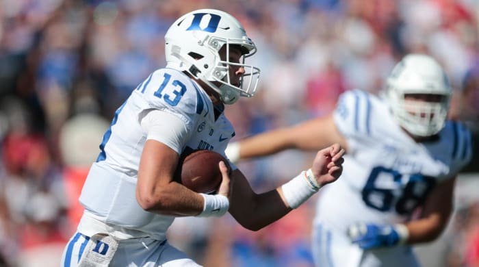 Duke sophomore quarterbak Riley Leonard (13) runs the ball during the first quarter of Saturday’s game against Kansas at David Booth Kansas Memorial Stadium.